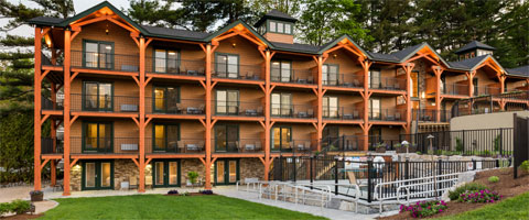 Looking across the lakefront lawn and the hot tub towards the main lodge at the Center Harbor Inn.